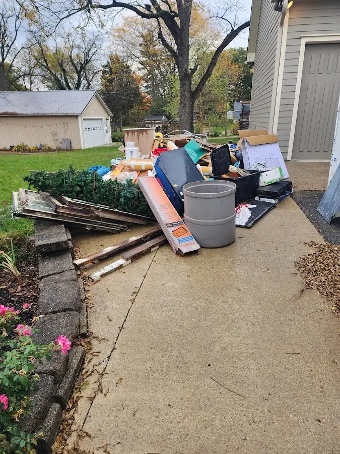 Dumpster being loaded with debris for Commercial Dumpster Rental in Oxford